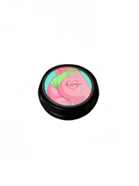 a jar with a pink flower on top of it