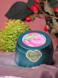 a blue tin with a pink flower on it